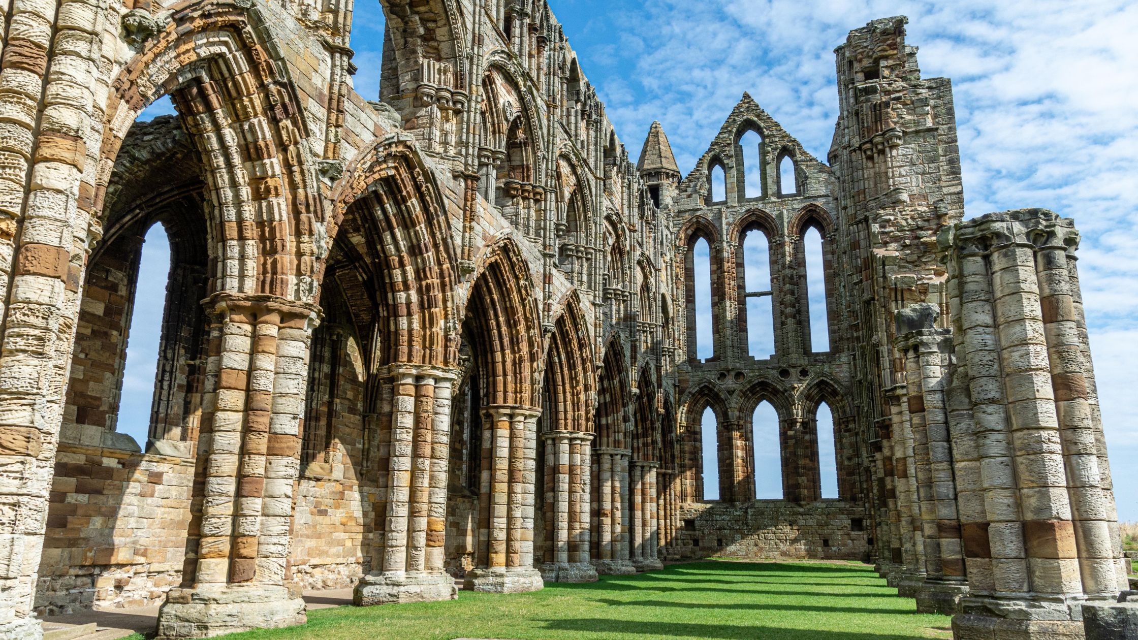 Ruins of Whitby Abbey stone with blue sky